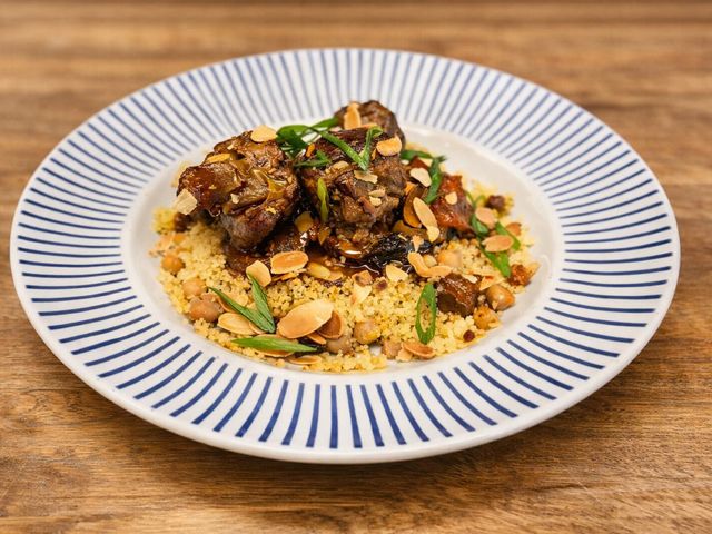 Les Saisons Agneau aux pruneaux façon tajine, amandes torréfiées et jus réduit aux épices Lamb with prunes, tajine‑style, toasted almonds and spiced reduced jus