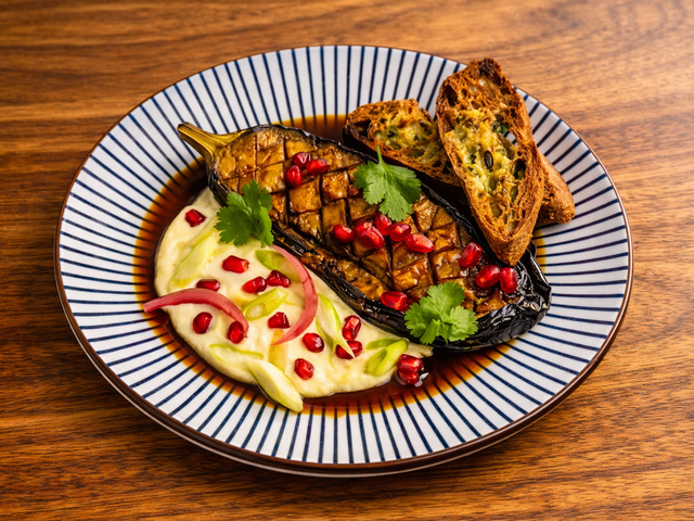 Les Saisons Les SaisonAubergine fumée glacée au soja, chèvre frais, grrenade — Smoked soy‑glazed aubergine, fresh goat’s cheese, pomegranates